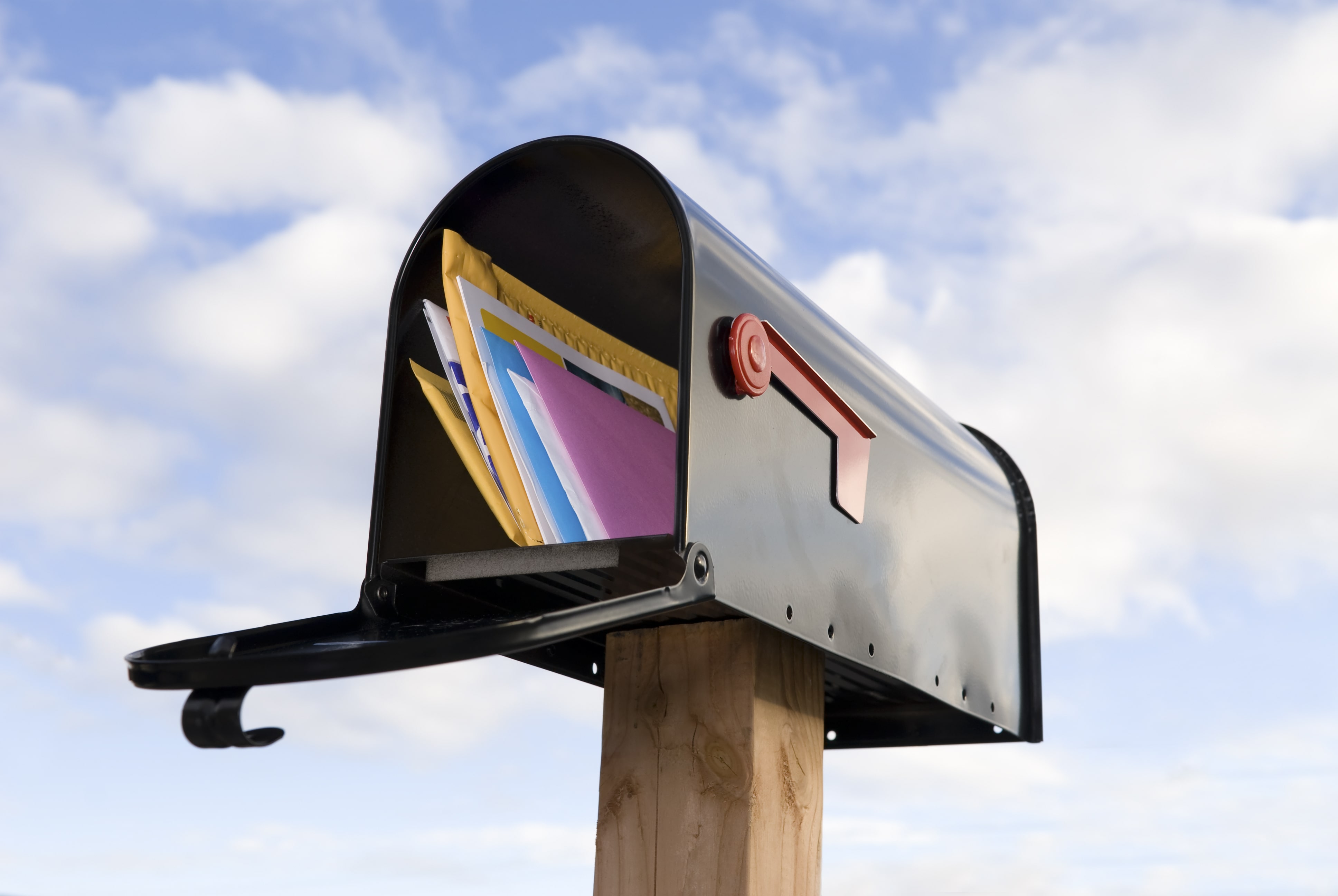 direct mail postcards and letters inside mailbox